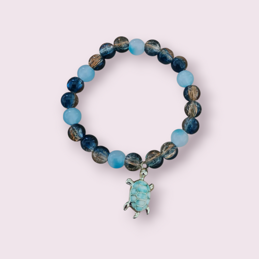 Glass bead with charm