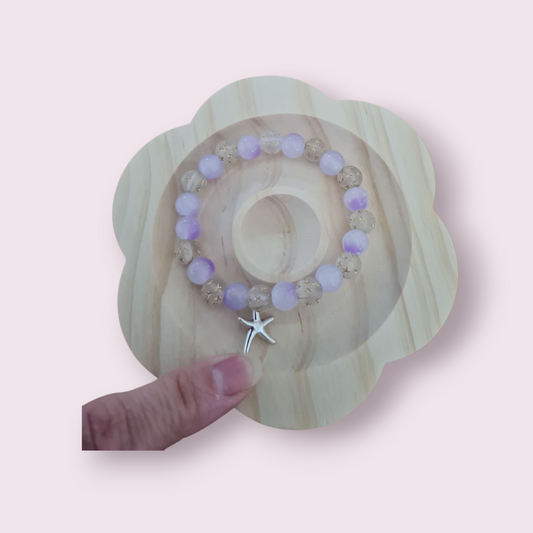Glass bead with charm
